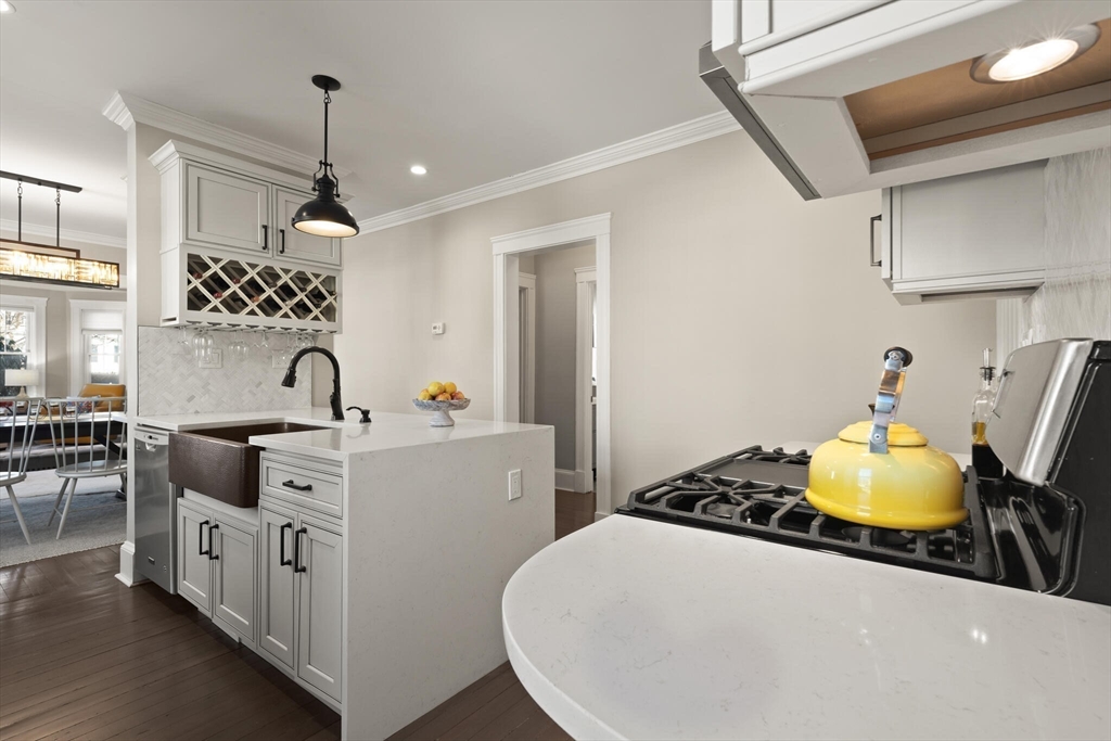 504 Main Street, Unit 1 Watertown, MA 02472 - Photo 8 of 35 a kitchen with sink a stove and chairs