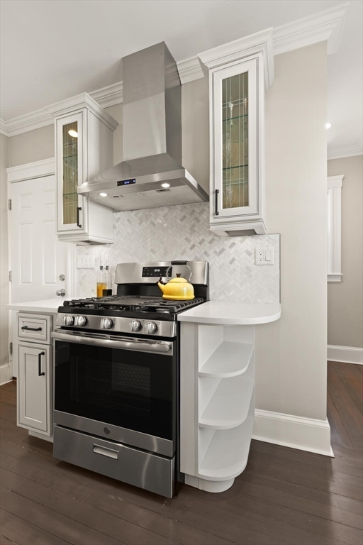 504 Main Street, Unit 1 Watertown, MA 02472 - Photo 9 of 35 a kitchen with stainless steel appliances a stove and white cabinets