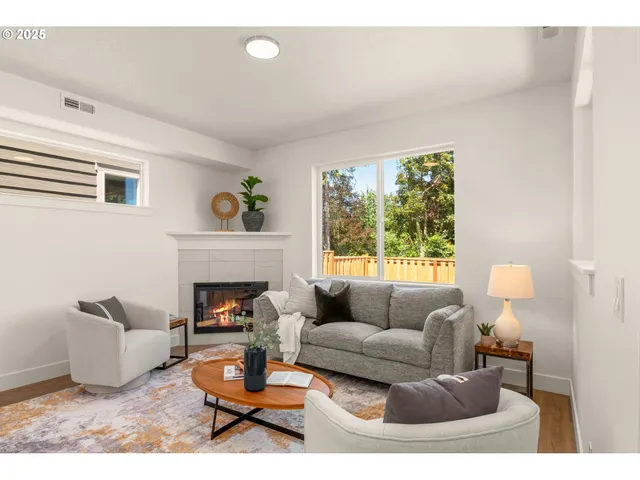 a living room with furniture and a fireplace