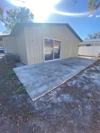a view of house with backyard and tree