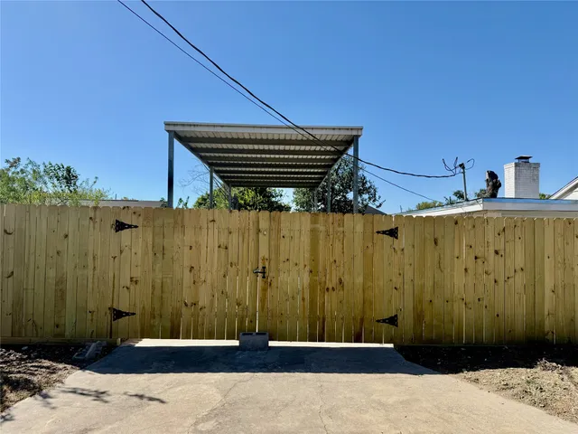 a view of a wooden door with a wooden fence