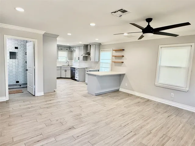 a view of kitchen with sink and refrigerator