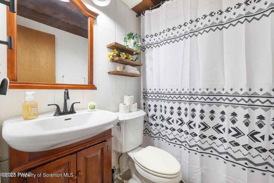 128-2779 Rockway Road Lake Ariel, PA 18436 - Photo 6 of 12 a bathroom with a sink a toilet and shower curtain