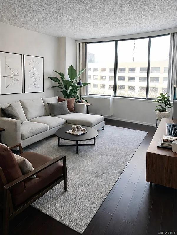 62-54 97th Place, Unit 4G Queens, NY 11374 - Photo 1 of 13 a living room with furniture and a large window
