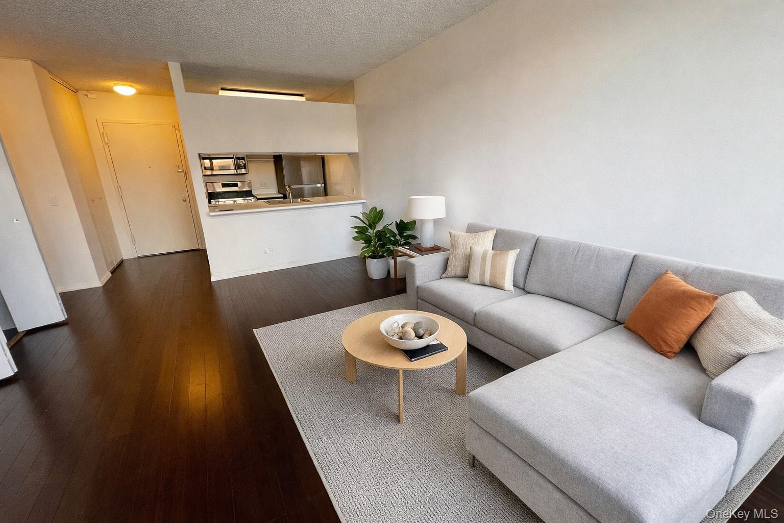 62-54 97th Place, Unit 4G Queens, NY 11374 - Photo 2 of 13 a living room with furniture and a wooden floor