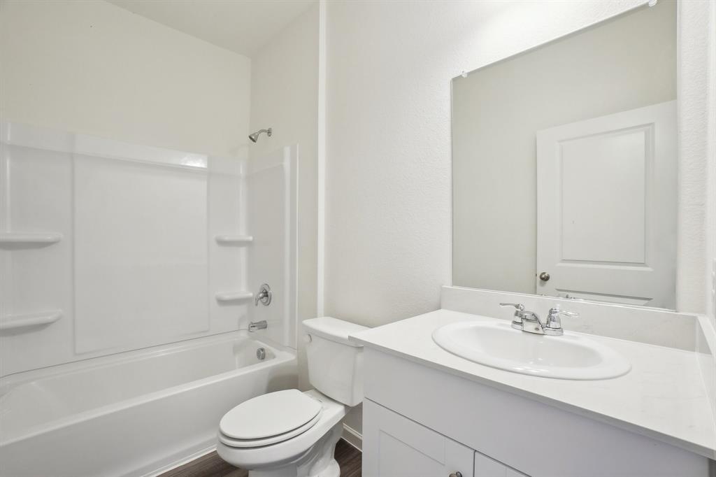 2104 Prairie Lane Melissa, TX 75454 - Photo 14 of 19 a bathroom with a sink a toilet and shower