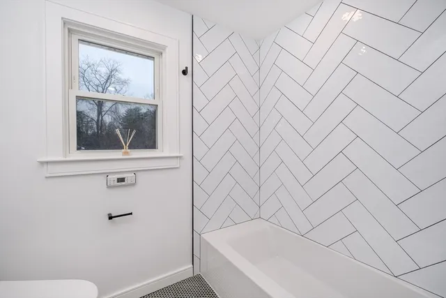 a bathroom with a bathtub and shower