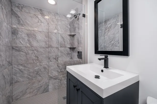 a bathroom with a sink mirror and vanity