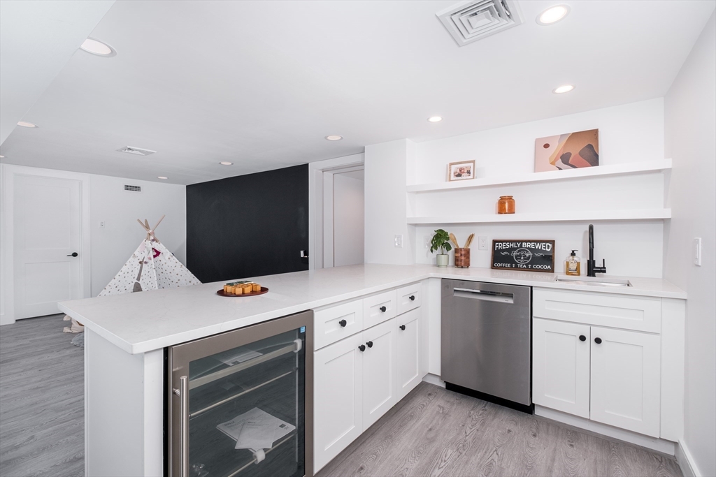 26 Harris Avenue Wellesley, MA 02481 - Photo 27 of 37 a kitchen that has a lot of cabinets in it and wooden floors