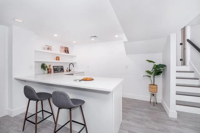 a view of kitchen with furniture and wooden floor
