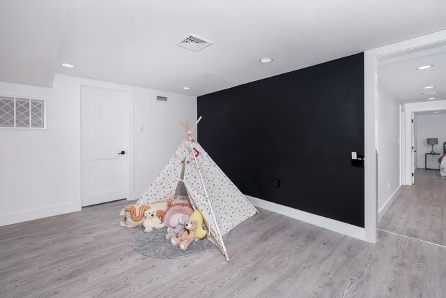 a view of a livingroom with wooden floor and entryway