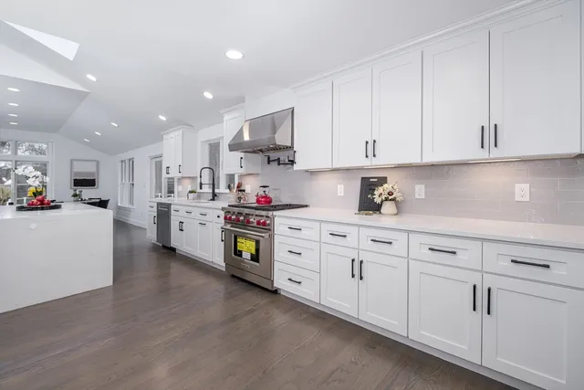 a kitchen with cabinets and window
