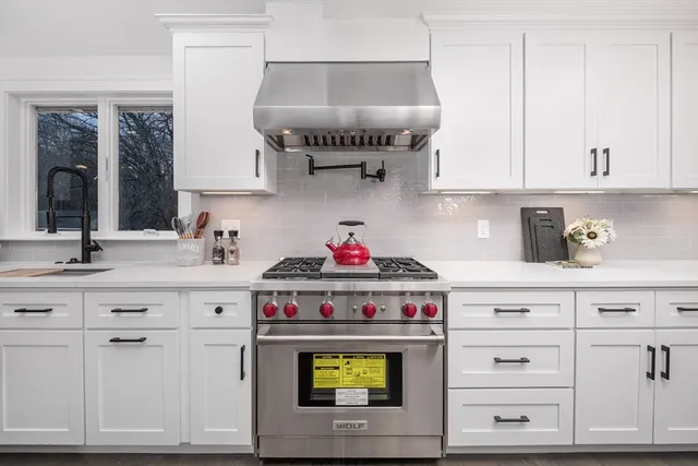 a kitchen with cabinets and a stove