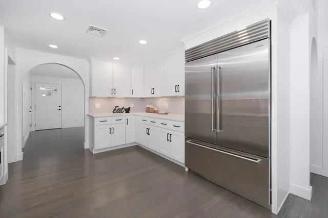 a kitchen with white cabinets and white stainless steel appliances
