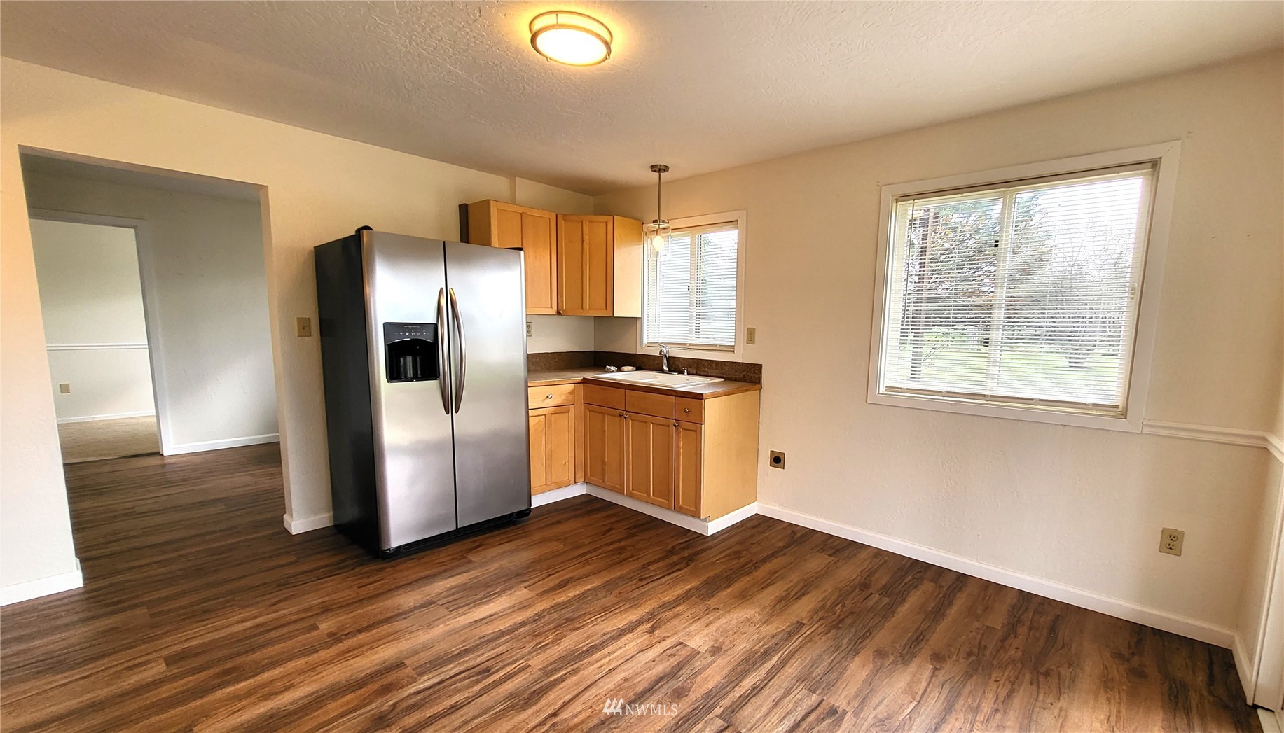 1040 Spath Road Sequim, WA 98382 - Photo 21 of 34 a kitchen with a refrigerator and wooden floor