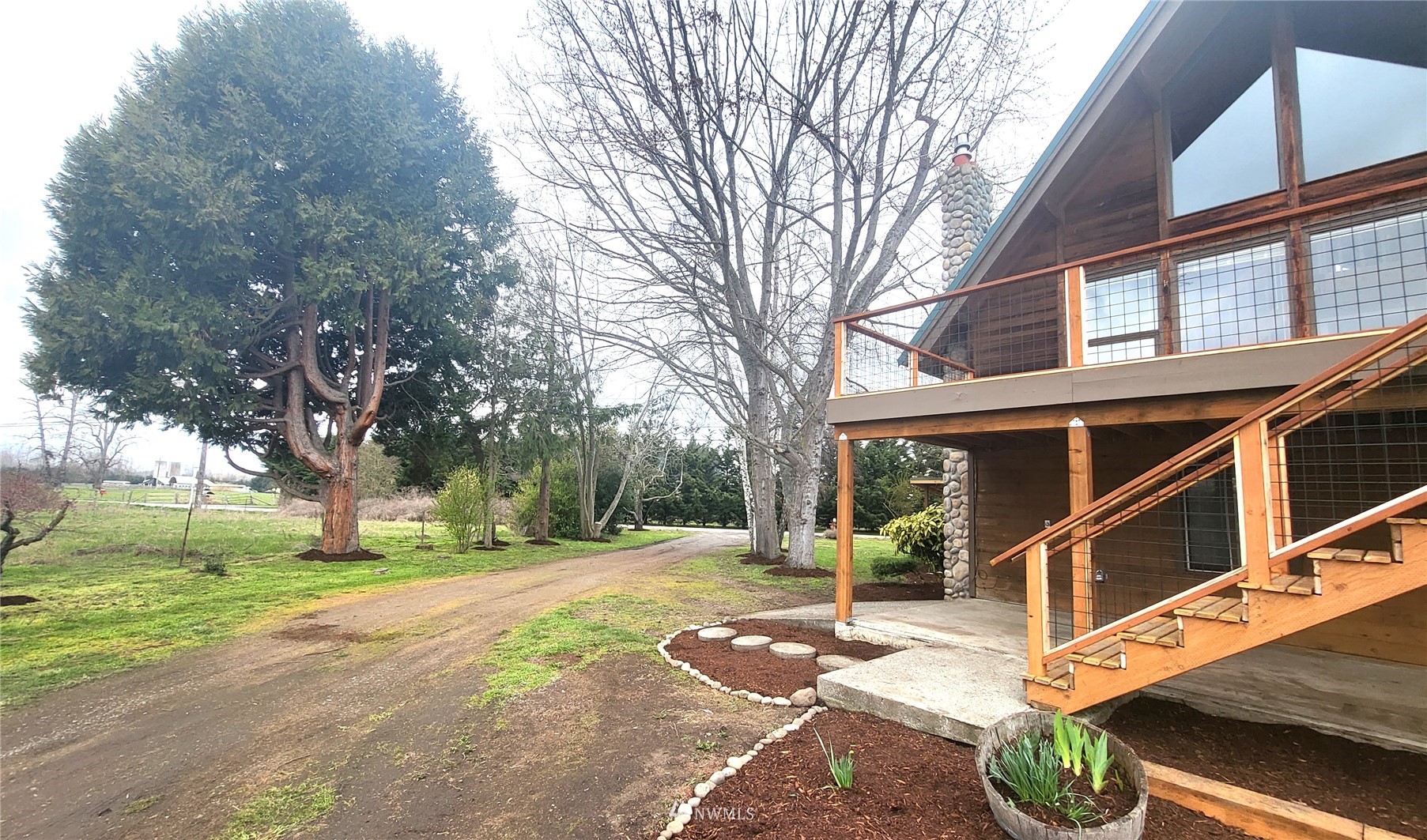 1040 Spath Road Sequim, WA 98382 - Photo 3 of 34 a view of a house with backyard and trees