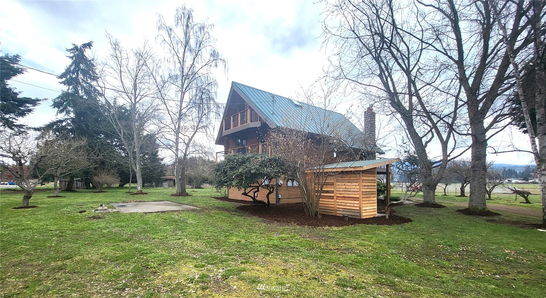 1040 Spath Road Sequim, WA 98382 - Photo 31 of 34 a view of a house with a back yard