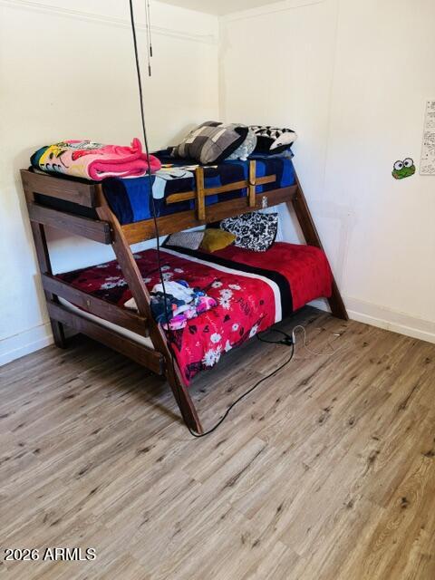 701 6th Green Street Douglas, AZ 85607 - Photo 7 of 10 a bedroom with wooden floor and a bed