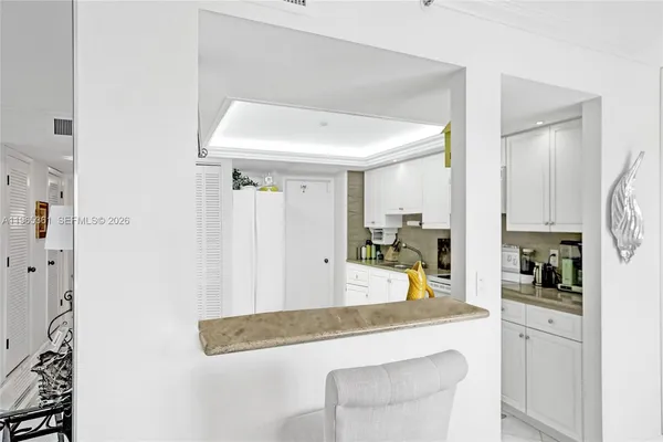 a view of a kitchen with furniture and wooden floor