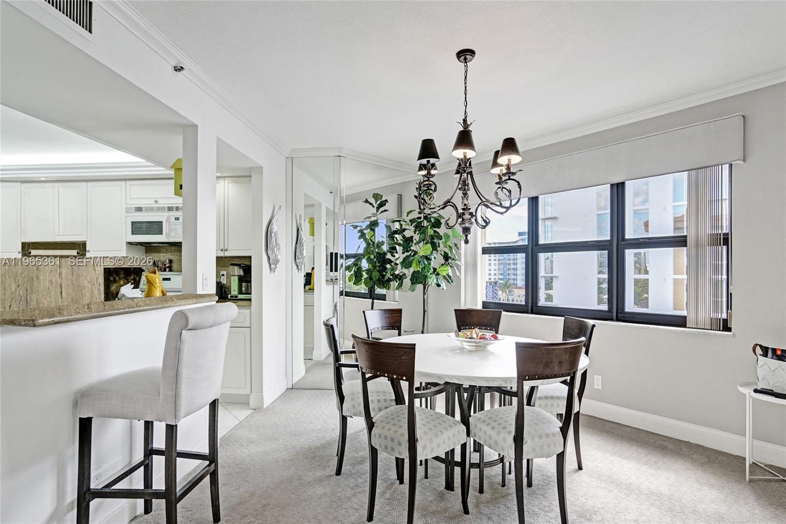501 North Riverside Drive, Unit 802 Pompano Beach, FL 33062 - Photo 17 of 70 a view of a dining room with furniture window and wooden floor