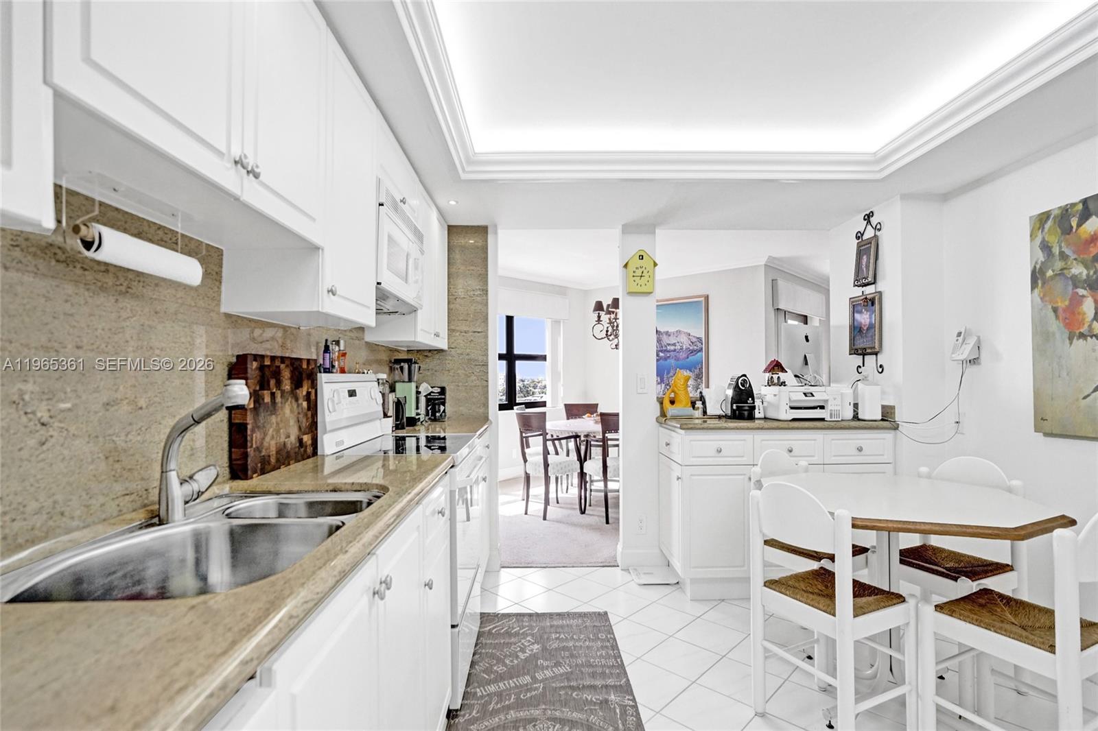 501 North Riverside Drive, Unit 802 Pompano Beach, FL 33062 - Photo 19 of 70 a kitchen with stainless steel appliances granite countertop a sink and a refrigerator
