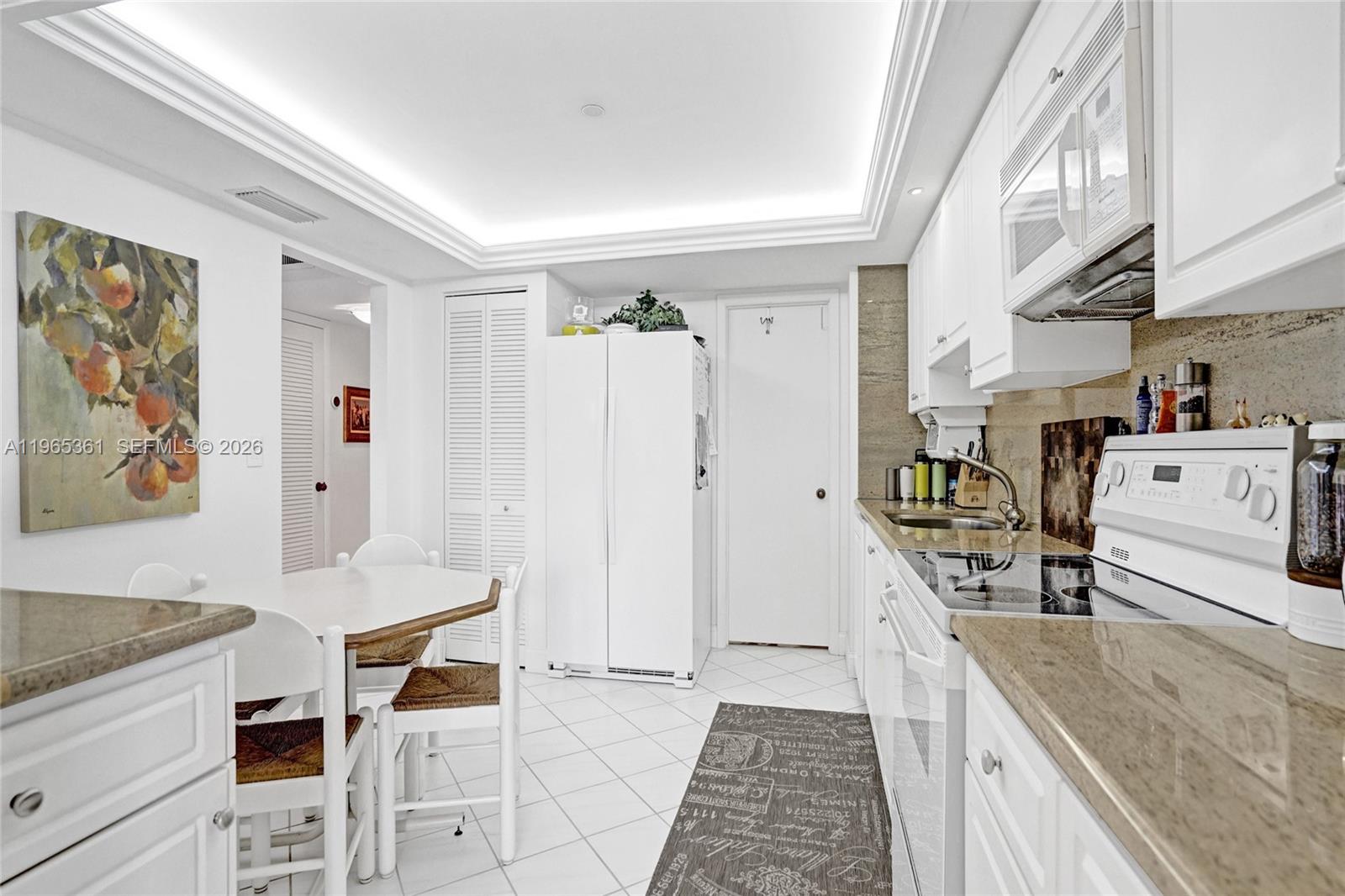 501 North Riverside Drive, Unit 802 Pompano Beach, FL 33062 - Photo 21 of 70 a view of a kitchen with furniture and wooden floor