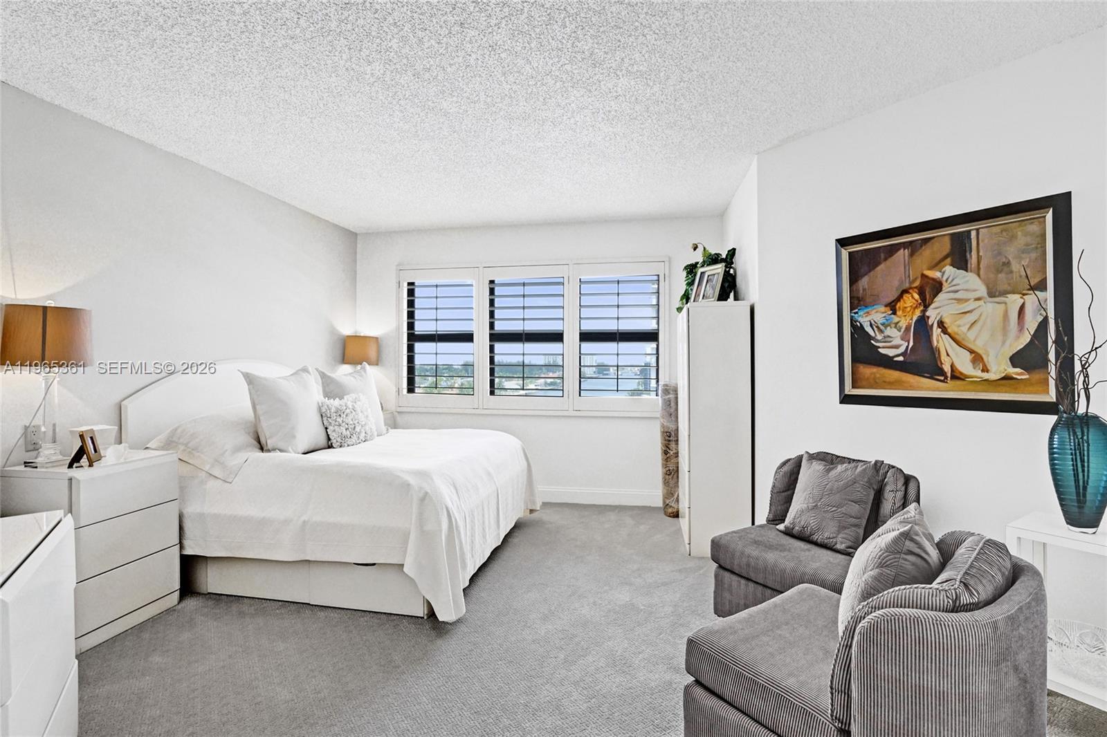 501 North Riverside Drive, Unit 802 Pompano Beach, FL 33062 - Photo 24 of 70 a spacious bedroom with a bed and a large window