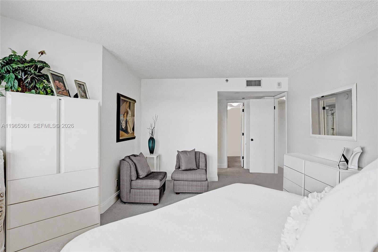 501 North Riverside Drive, Unit 802 Pompano Beach, FL 33062 - Photo 27 of 70 a bedroom with a bed and a potted plant