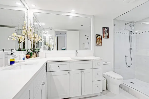 a bedroom with a bed next to a window with a flat screen tv