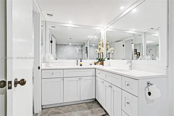 a bedroom with a balcony a bed and a flat screen television