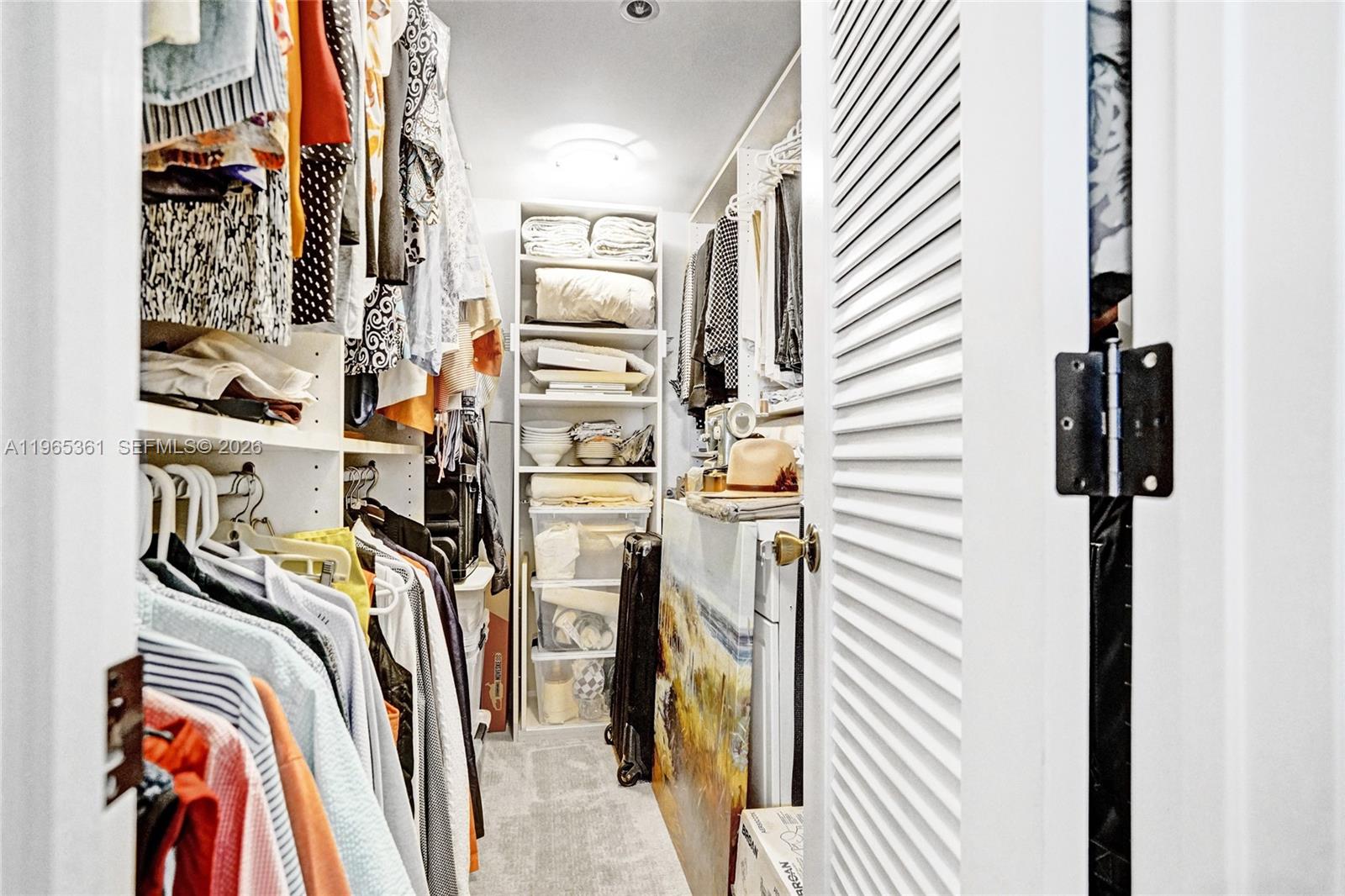 501 North Riverside Drive, Unit 802 Pompano Beach, FL 33062 - Photo 32 of 70 a view of walk in closet with clothes and shoes