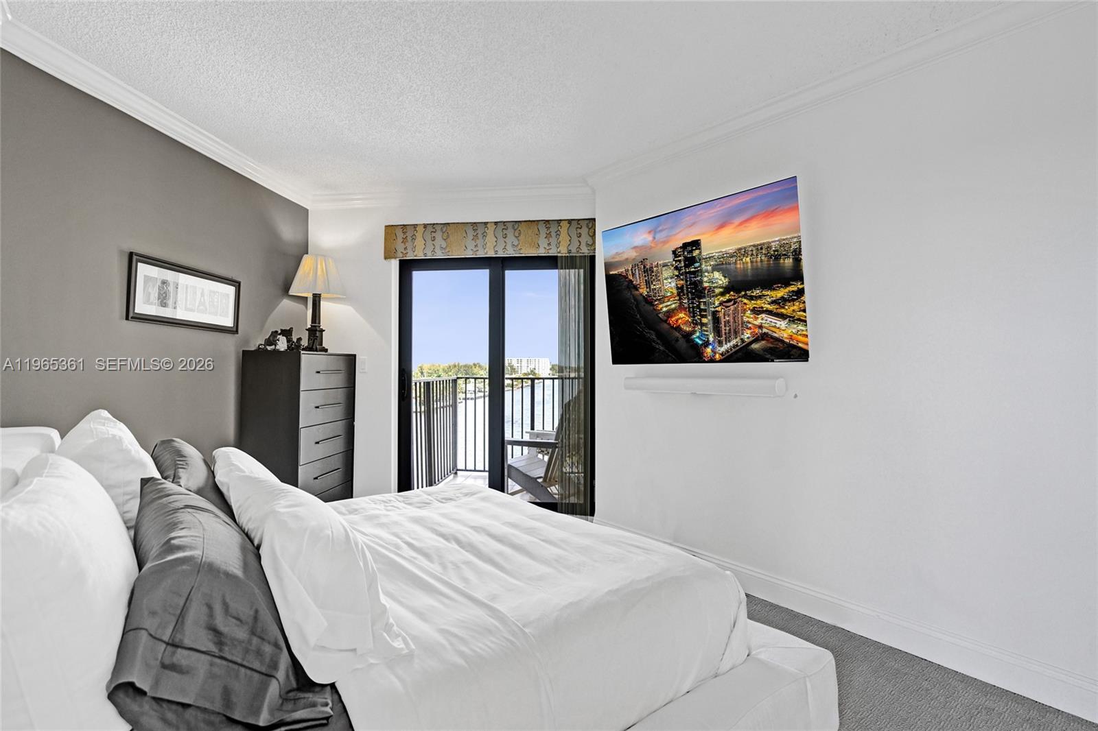 501 North Riverside Drive, Unit 802 Pompano Beach, FL 33062 - Photo 36 of 70 a bedroom with a bed and a painting on the wall