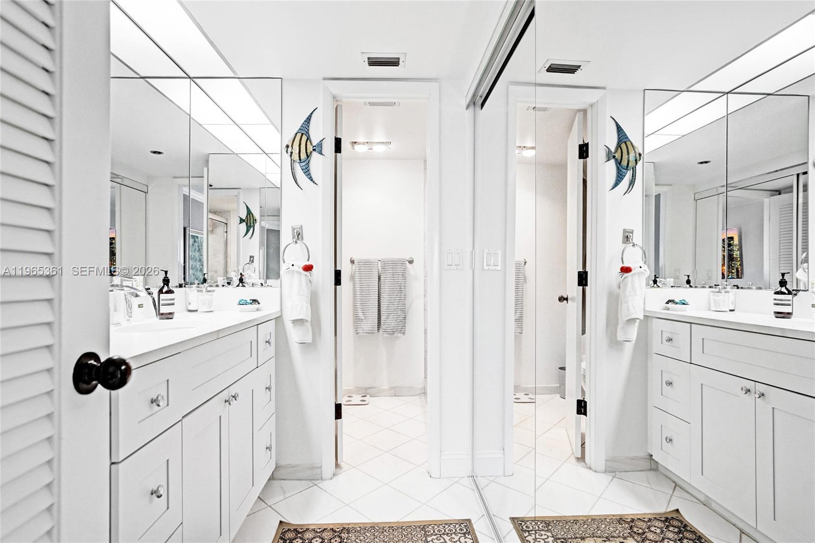 501 North Riverside Drive, Unit 802 Pompano Beach, FL 33062 - Photo 38 of 70 a bathroom with a double vanity sink a mirror a shower and vanity