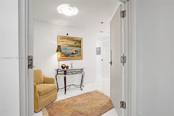 a view of a hallway with white walls and white doors