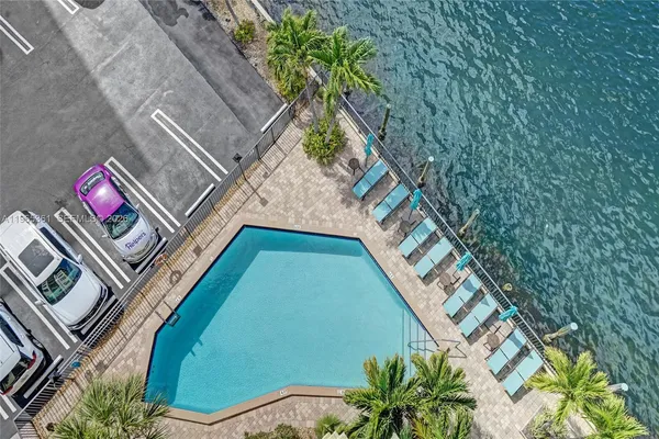 a living room with furniture flat screen tv and a large window