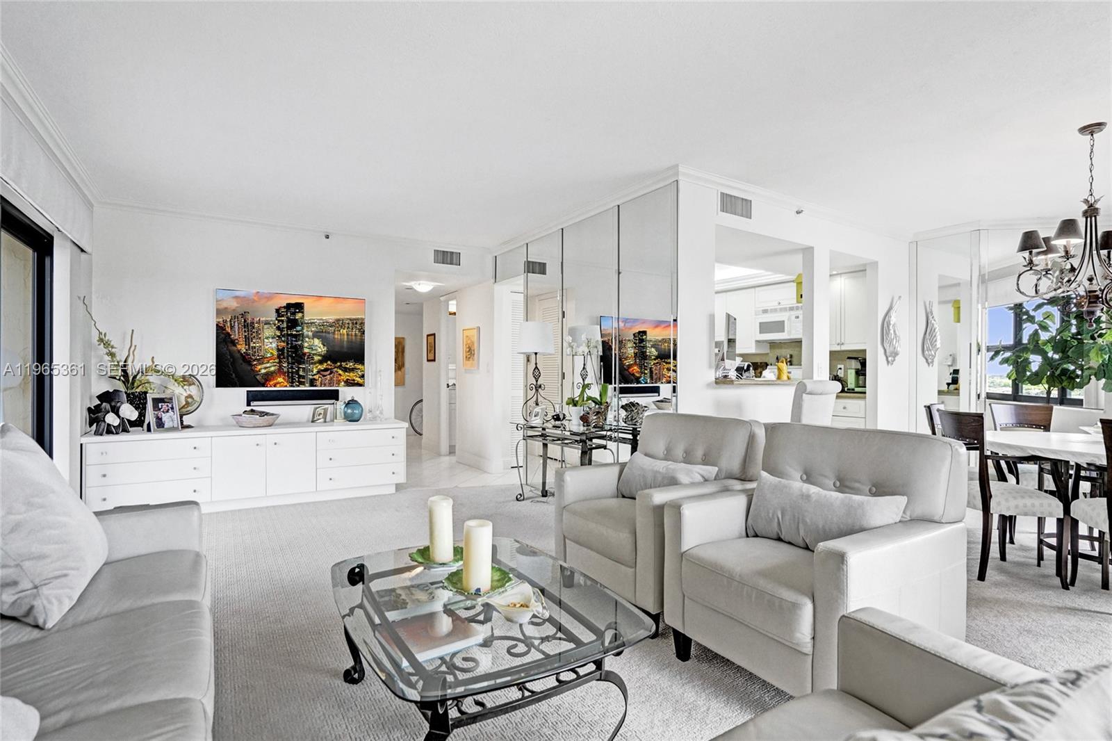 501 North Riverside Drive, Unit 802 Pompano Beach, FL 33062 - Photo 10 of 70 a living room with furniture and a flat screen tv