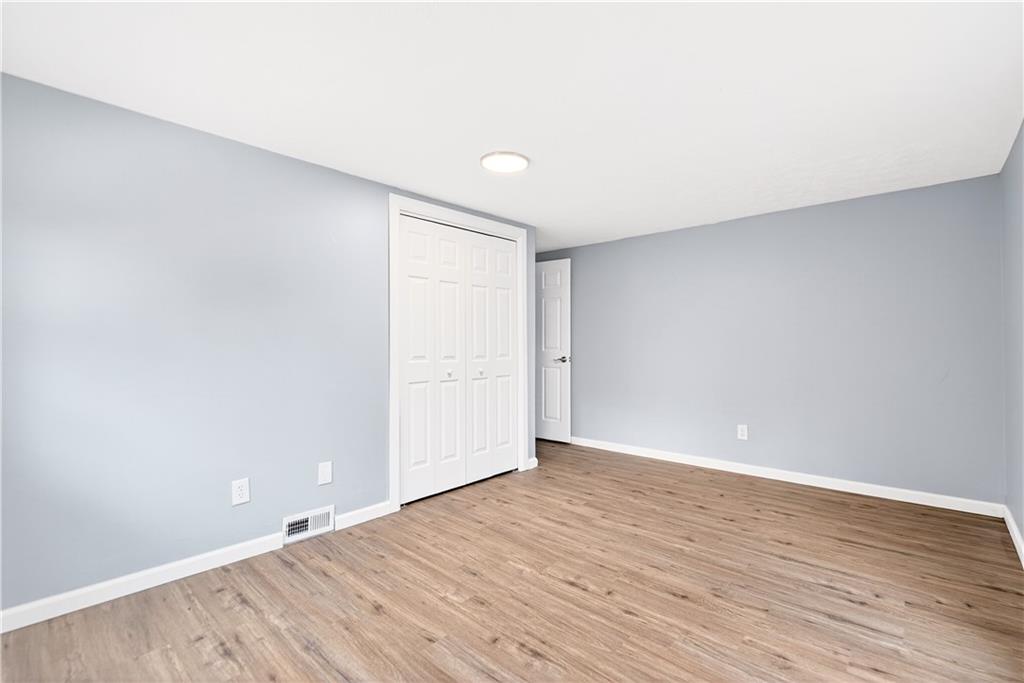 93 Old 51 Road Perryopolis, PA 15473 - Photo 29 of 44 a view of an empty room with wooden floor
