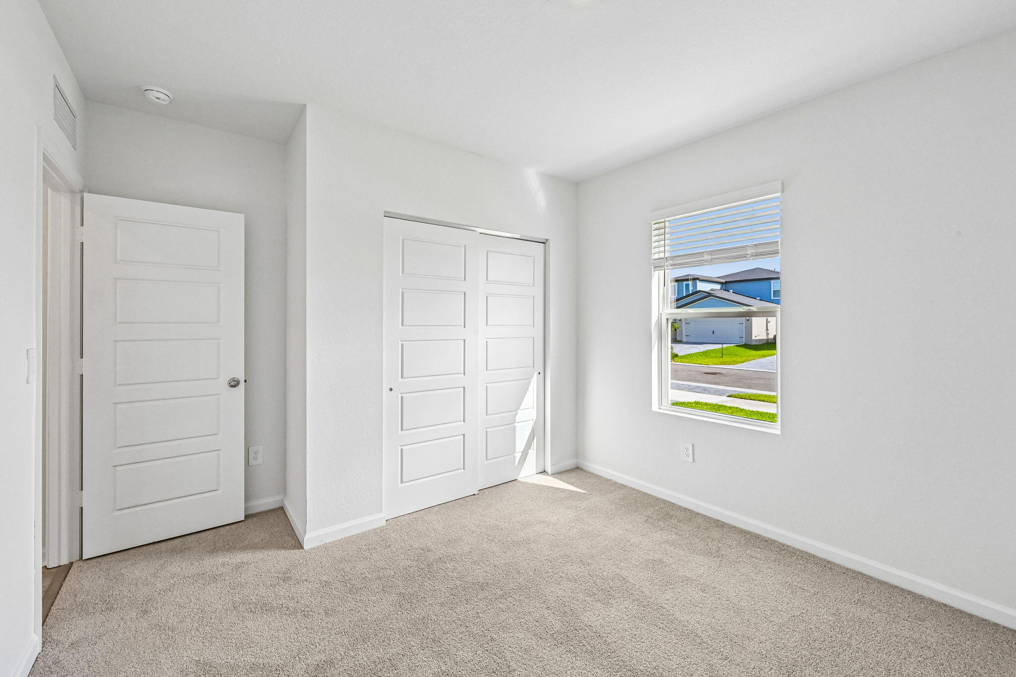 14503 Southwest New Dawn Road Indiantown, FL 34956 - Photo 17 of 42 an empty room with windows and couch