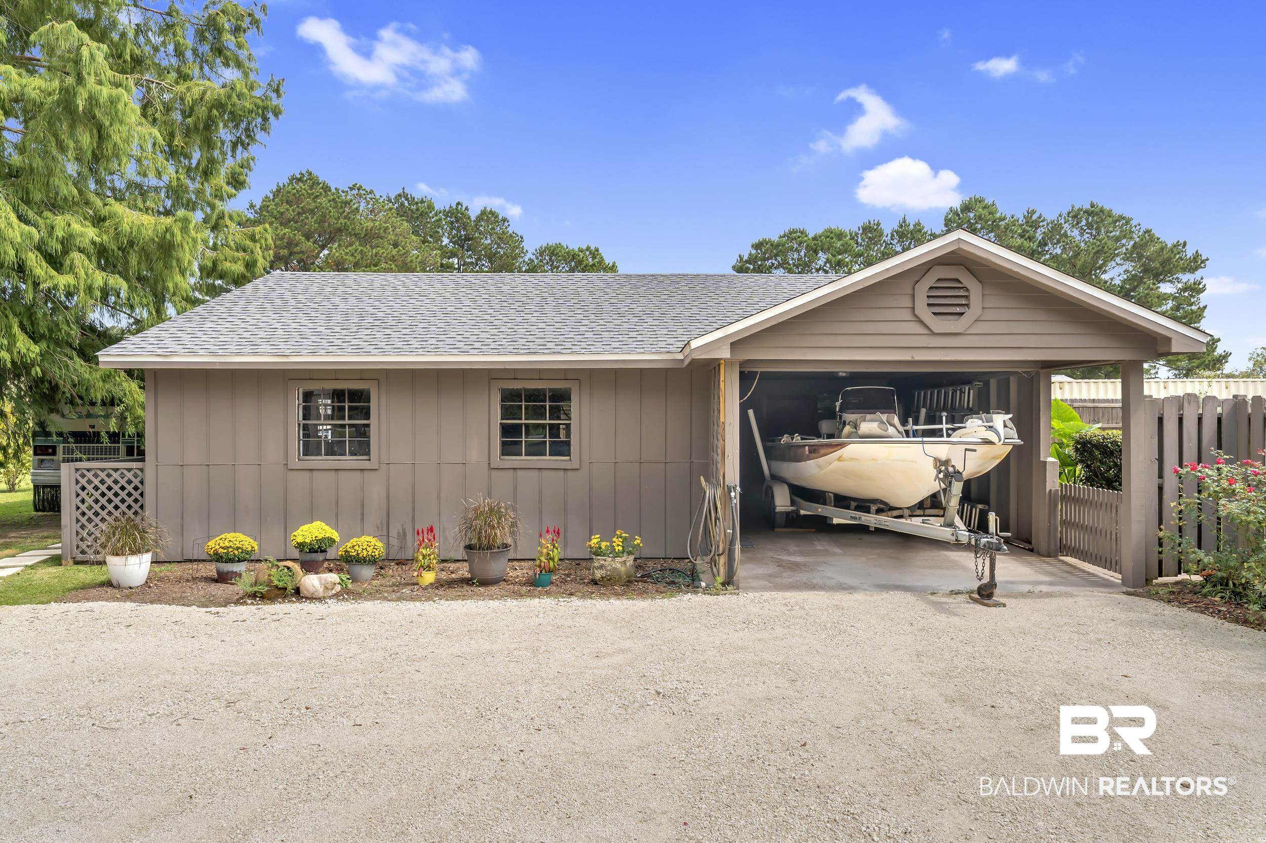 19090 Gunnison Road Fairhope, AL 36532 - Photo 39 of 42 Ranch-style house featuring a shingled roof, driveway, and board and batten siding