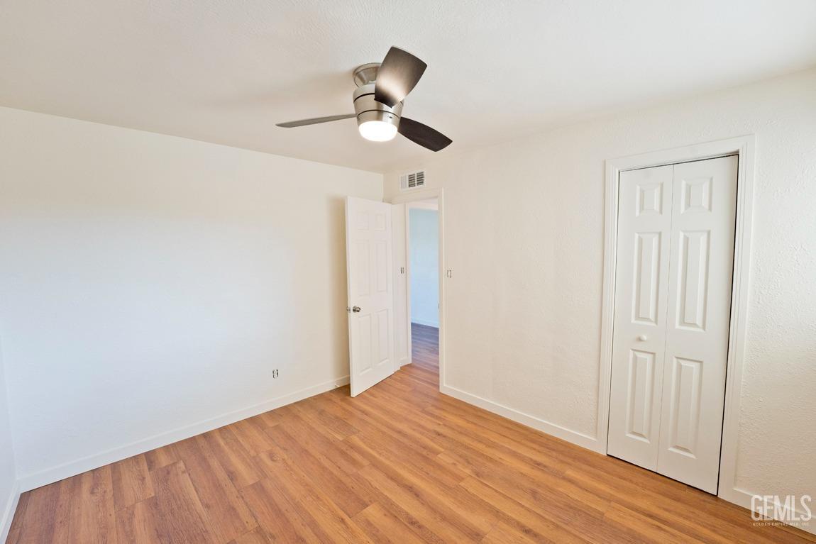 Undisclosed Address Bakersfield, CA 93308 - Photo 12 of 23 a view of empty room with wooden floor