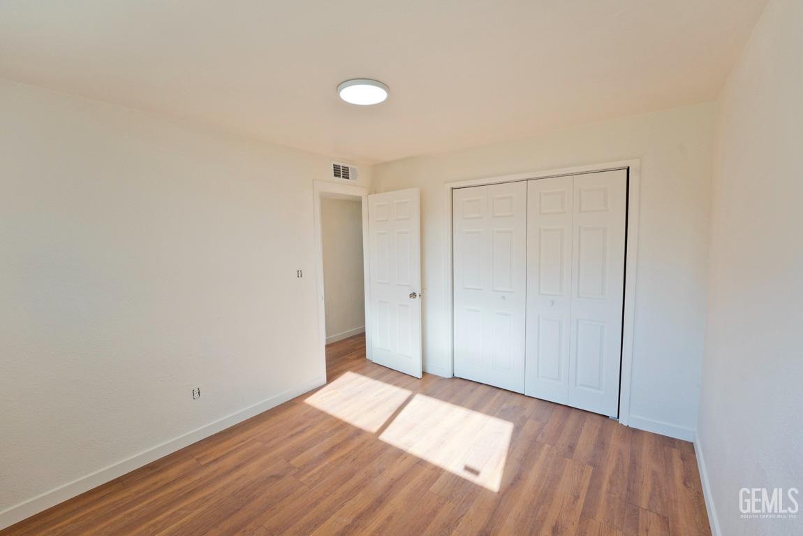 Undisclosed Address Bakersfield, CA 93308 - Photo 13 of 23 a view of an empty room and wooden floor