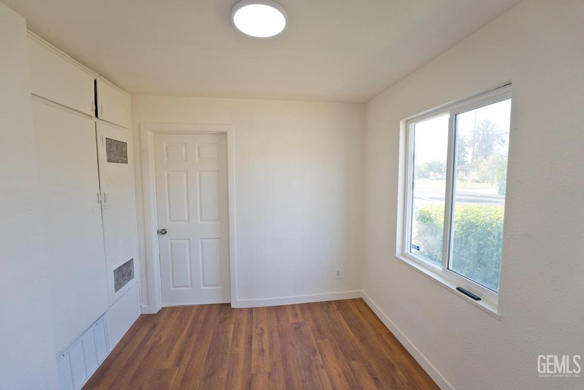 Undisclosed Address Bakersfield, CA 93308 - Photo 17 of 23 a view of a room with wooden floor and windows