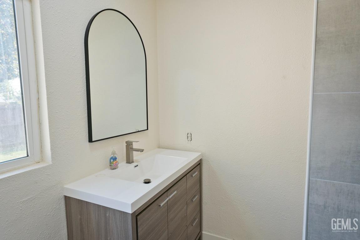 Undisclosed Address Bakersfield, CA 93308 - Photo 20 of 23 a bathroom with a sink and a mirror