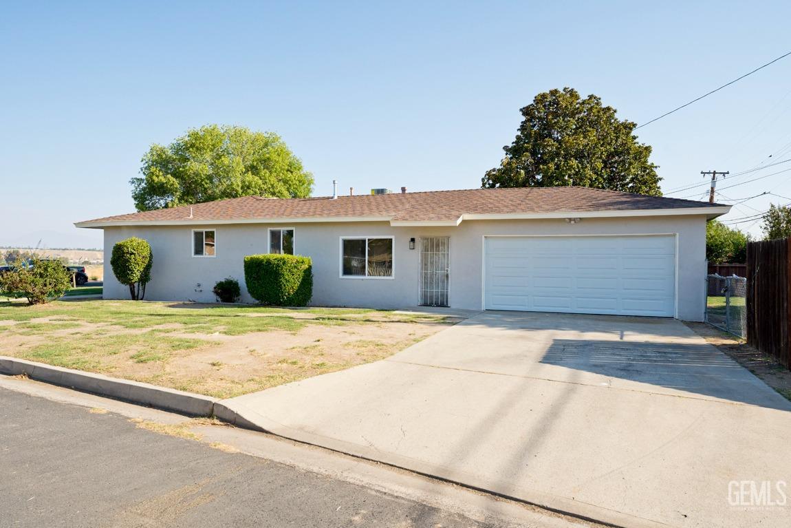 Undisclosed Address Bakersfield, CA 93308 - Photo 2 of 23 front view of a house with a garage