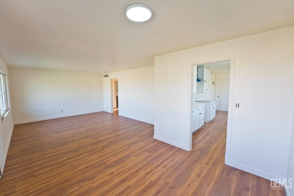 Undisclosed Address Bakersfield, CA 93308 - Photo 6 of 23 a view of empty room with wooden floor