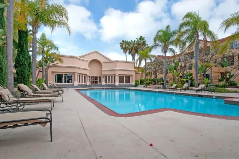 a view of a house with a swimming pool and sitting area