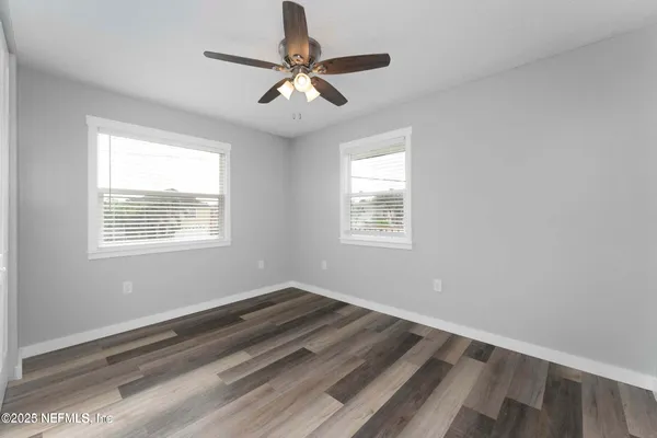 a view of room with window and ceiling fan