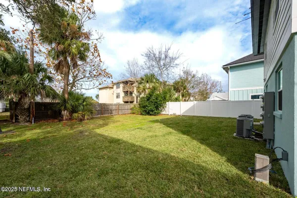 a view of backyard of house with green space