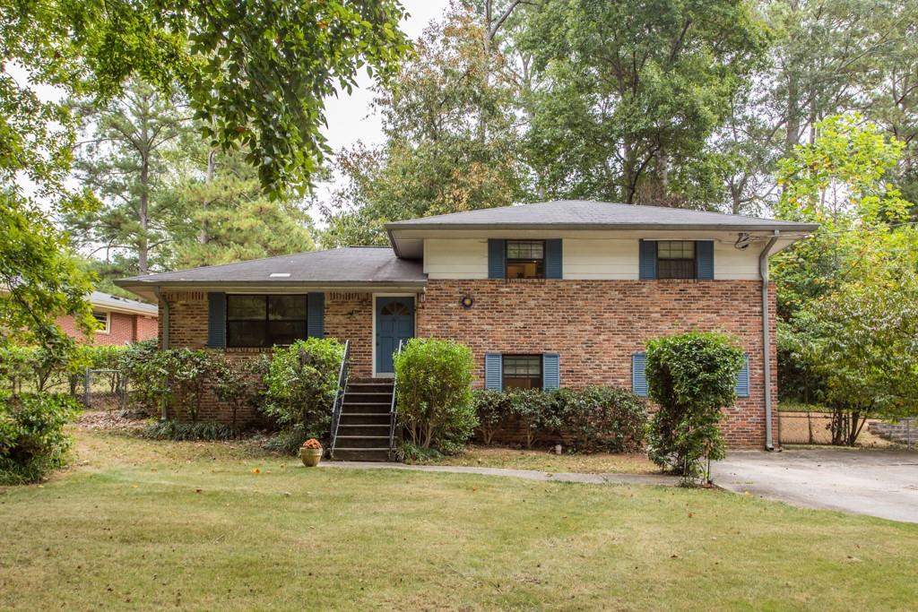 1566 Moncrief Circle Decatur, GA 30033 - Photo 1 of 1 a front view of a house with a garden