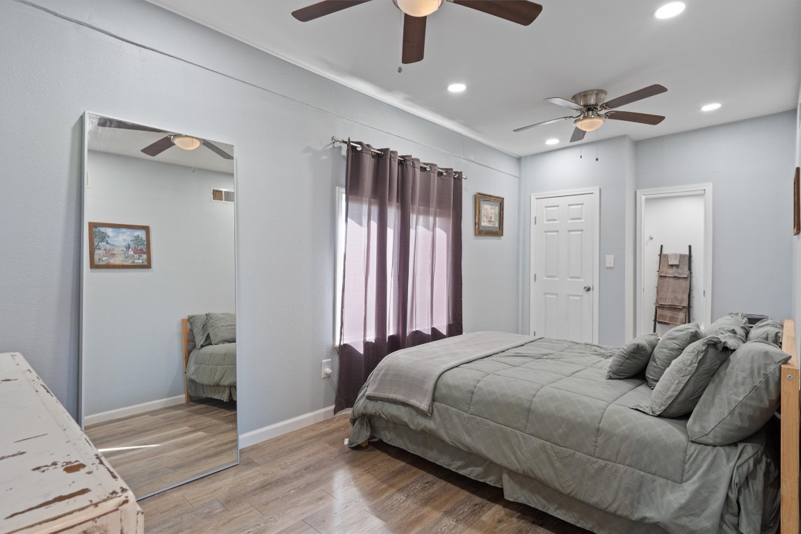 1102 Beech Street Taylor, TX 76574 - Photo 11 of 40 a bedroom with bed and wooden floor